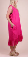 Sleeveless hot pink linen dress with lace trim and ruffle hem, modeled side view