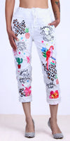 White cropped pants with colorful tropical and animal print designs, drawstring waist