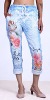 Woman wearing light blue floral print drawstring jogger pants with rolled cuffs