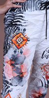Women's pants with black and white zebra print, orange geometric pattern, and floral design