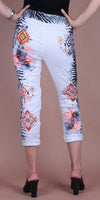 White cropped pants with geometric and floral prints, black zebra pattern accents, worn by woman