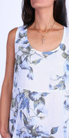 Sleeveless white floral linen dress with blue and green botanical print, scoop neckline.