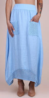 Light blue linen maxi skirt with crochet pockets and hem, worn with nude heels