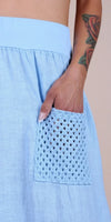Light blue linen skirt with crochet pocket and floral tattooed arm