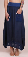 Navy blue linen maxi skirt with crochet pockets and crochet hem, modeled on a woman