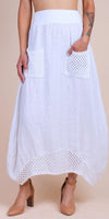 White linen maxi skirt with crochet pockets and hem, styled with block heel shoes.