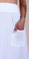 White linen skirt with crochet pocket detail and tattooed hand