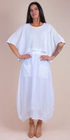 Woman modeling white perforated linen dress with short sleeves and front pockets