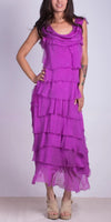 Woman wearing a sleeveless magenta tiered midi dress with raw edges and beige sandals