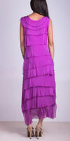 Back view of woman in sleeveless layered fuchsia dress and high heels