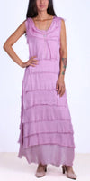 Woman wearing a sleeveless lavender tiered maxi dress with raw edge details and nude heels