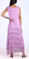 Woman wearing a sleeveless lavender tiered maxi dress with frayed edges, back view