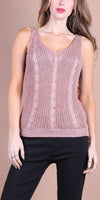 Woman wearing a mauve cable knit sleeveless top with V-neck and black pants