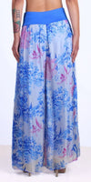Back view of wide leg blue floral palazzo pants with a high waist and flowy fabric