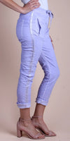 Woman wearing light purple linen jogger pants with side stripe and ankle strap heels