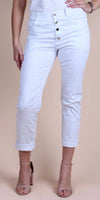 Woman wearing white high-waisted button front pants with rolled cuffs and nude heels