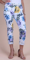 White floral print pants with blue, yellow, and purple flowers, rolled cuffs, and tie waist