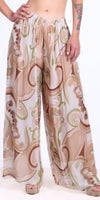 Wide-leg pants with beige, green, and brown abstract swirl print and elastic waistband