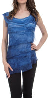 Woman wearing a sleeveless layered blue top with asymmetric hem paired with black pants