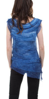 Woman wearing blue sleeveless tiered tunic top with asymmetrical hem and black pants, back view