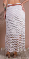 Back view of a woman wearing a white crochet maxi skirt with openwork pattern