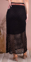 Black crochet maxi skirt with fishnet pattern and brown belt, styled with block heels