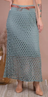 Woman wearing sage green crochet mesh maxi skirt with brown belt and block heels