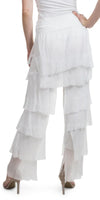 Woman wearing white tiered ruffle palazzo pants and heels, back view