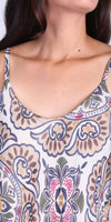 Close-up of woman wearing a sleeveless top with colorful Italian-inspired floral print.