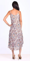 Woman wearing sleeveless midi dress with colorful floral medallion pattern and high heels