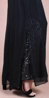 Black maxi dress with sheer overlay and sequin detail, open front, and heeled sandals