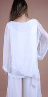 Back view of woman wearing white sheer long sleeve blouse and wide leg pants