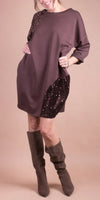 Woman modeling taupe sequin-accented shift dress with knee-high suede boots