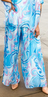 Wide-leg pants with vibrant blue and pink swirled print, flowy lightweight fabric