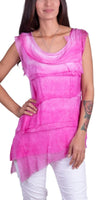 Woman wearing sleeveless pink layered asymmetrical tunic with white pants