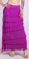 Woman wearing a magenta tiered maxi skirt with frayed edges and beige sandals