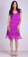 Woman wearing a sleeveless purple layered chiffon dress with neutral platform heels