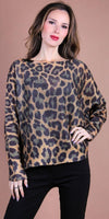 Woman wearing a leopard print knit sweater with long sleeves and black pants