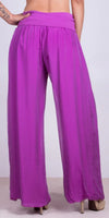 Back view of woman wearing wide leg, high-waisted magenta silk pants with heels