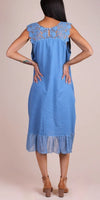 Woman wearing blue midi dress with lace yoke and ruffle hem, back view