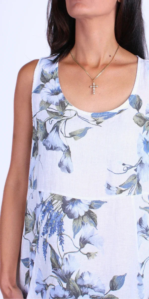 Sleeveless white floral linen dress with blue and green botanical print, scoop neckline.