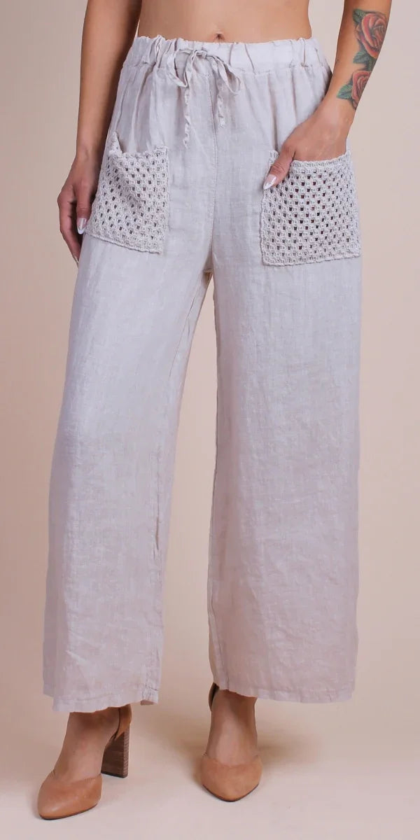 Wide-leg linen pants with drawstring waist and crochet front pockets, neutral color