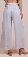 Back view of woman wearing wide-leg linen pants in light beige with high waist
