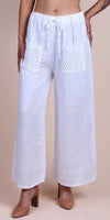 Women's white linen wide leg pants with crochet front pockets and drawstring waist
