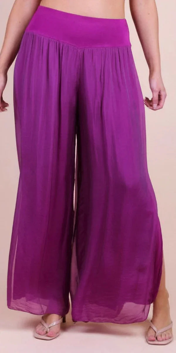 Woman wearing wide-leg sheer magenta palazzo pants with solid waistband
