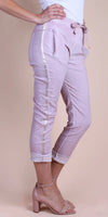 Light pink linen cropped pants with satin side stripe, drawstring waist, and rolled cuffs
