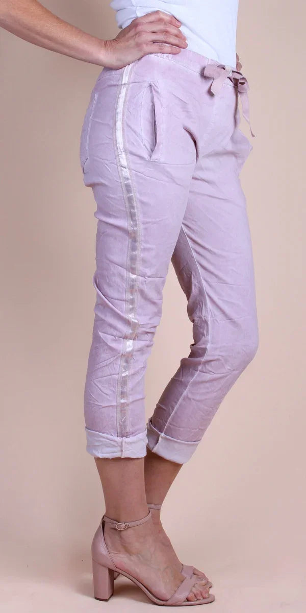 Light pink linen cropped pants with satin side stripe, drawstring waist, and rolled cuffs