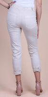 Back view of woman wearing light beige cropped pants with rolled cuffs and pink block heels