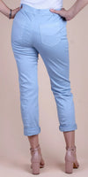Back view of woman wearing light blue cropped jeans and nude block heel shoes