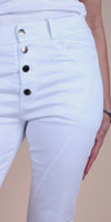 High-waisted white skinny jeans with exposed silver buttons and side pockets